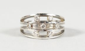 AN 18CT GOLD TRIPLE ROW DIAMOND RING.