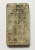 A CHINESE JADE PENDANT DECORATED WITH CALLIGRAPHY. 2.5ins high.