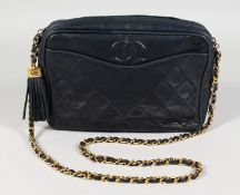 A BLUE CHANEL BAG with gilt metal strap. 9.5ins long.