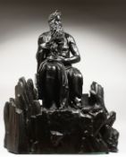 AFTER MICHELANGELO - AN IMPRESSIVE LARGE BRONZE OF MOSES seated on rocks, a tablet under his arm.