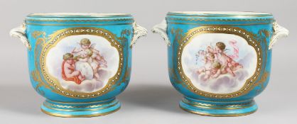 A LARGE PAIR OF 19TH CENTURY SEVRES PALE BLUE JARDINIERES, with shell handles and painted with putti