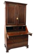 A GEORGE III MAHOGANY BUREAU/CUPBOARD BOOKCASE, with a moulded cornice over a pair of panelled doors