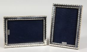 A PAIR OF MODERN SILVER PHOTOGRAPH FRAMES. 7ins x 5ins.