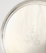 A PLAIN GEORGE III CIRCULAR SALVER, with reeded edge on three curving feet. London 1794. Makers: T.