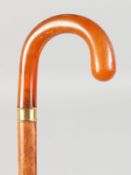 A GOOD AMBER HANDLED WALKING STICK with gold band. 36ins long.