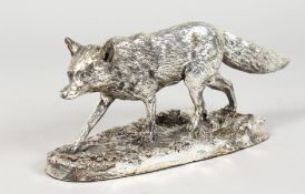 A SILVER MODEL OF A FOX on a naturalistic base. 9ins long.