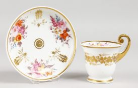 A 19TH CENTURY PARIS PORCELAIN PEDESTAL COFFEE CUP AND SAUCER, painted with flowers, probably in