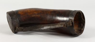 A LARGE EARLY 18TH CENTURY HORN DRINKING VESSEL with leather strap, dated 1710, with script. 11ins