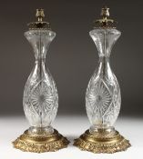 A LARGE PAIR OF CUT GLASS BRASS LAMP BASES.