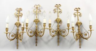 A SET OF FOUR CLASSICAL STYLE ORMOLU TWIN-BRANCH WALL APPLIQUES, with ribbons and swags. 22ins