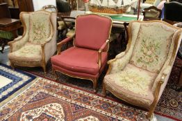 A pair of French style beech framed armchairs with needlework upholstered backs, arms and seats with