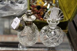 A cut glass and silver-plated perfume atomiser and a cut glass scent bottle.