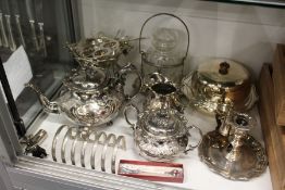 A plated three-piece tea service and other plated items.