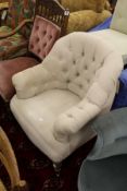 A Victorian style button upholstered armchair.