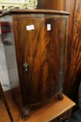 A mahogany bow fronted bedside cupboard.
