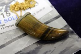 A tooth shaped pendant and chain.