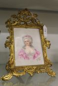 G Goger, head and shoulders portrait of a young lady on porcelain, in a decorative ormolu easel
