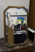 A small decoratively framed mirror.