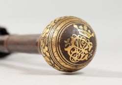 A parasol with decorative gold inlaid handle.