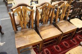 A set of six 19th century elm solid seat dining chairs with pierced vase shaped splats.