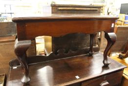 A mahogany stand on cabriole legs.