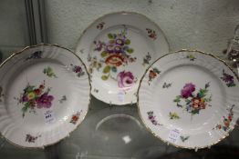 Three floral decorated cabinet plates.