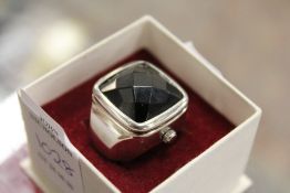 A ring watch, boxed.
