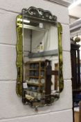 A decorative engraved glass Art Deco wall mirror.