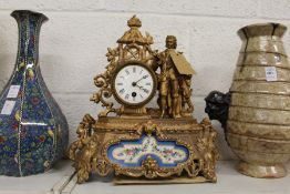 A French gilt decorated spelter mantle clock with porcelain panels.