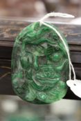 A carved jade amulet.