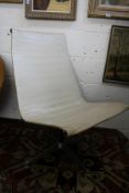 Charles Eames, a cream leather upholstered swivel side chair.