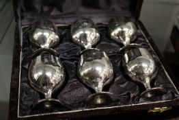 A boxed set of silver-plated miniature goblets.