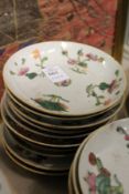 Ten small Chinese floral decorated saucers.