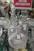 Three cut glass decanters.