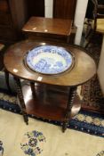 A 19th century mahogany wash stand with blue and white porcelain bowl, with two tiers united by
