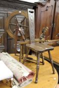 A spinning wheel and a spinning chair.