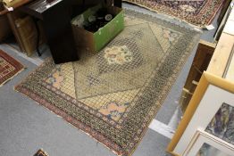 A Persian rug, beige ground with central floral motif and similar corner decoration.