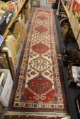 A good Persian runner / hall carpet, beige ground with eight large medallions.