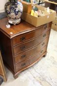 A mahogany serpentine fronted chest of drawers.