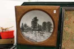 A large painted circular porcelain dish mounted in an oak frame.