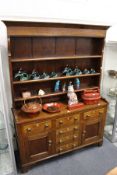 A good elm and mahogany dresser with Delft rack four central drawers flanked by two further
