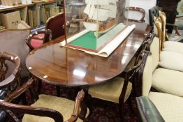 A good Regency design mahogany twin pillar dining table with two leaves.