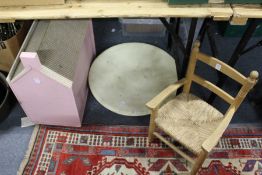 A child's chair, a doll's house and a large dish.