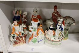 Staffordshire flatback figures and a spill vase depicting Red Riding Hood and others.