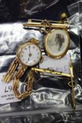 A small collection of 9ct gold bar brooches, a 9ct gold ladies' wristwatch and a locket.