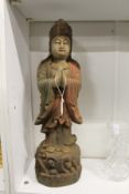 A Chinese carved and painted wood figure of standing deity.