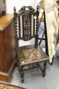 A carved oak hall chair.