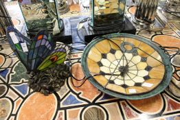 A decorative stained glass butterfly shaped lamp base together with a stained glass ceiling shade.