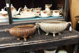 Two small cast iron troughs.