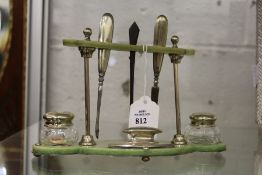A ladies' part silver manicure set on original stand.